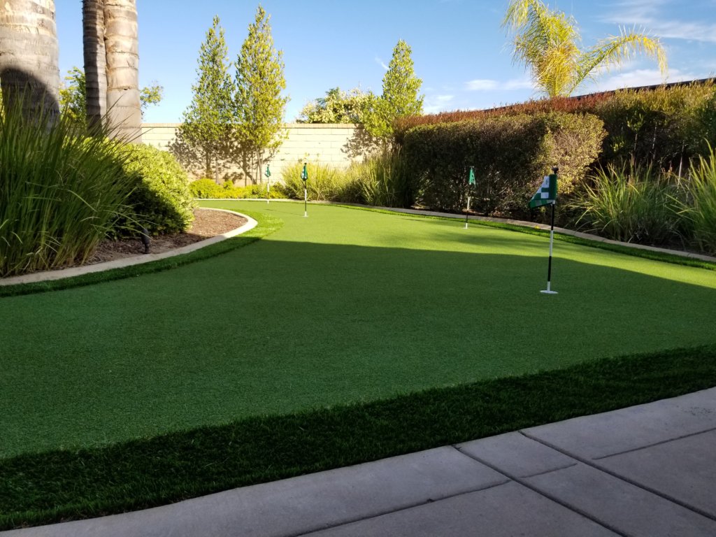 Backyard putting green with artificial turf